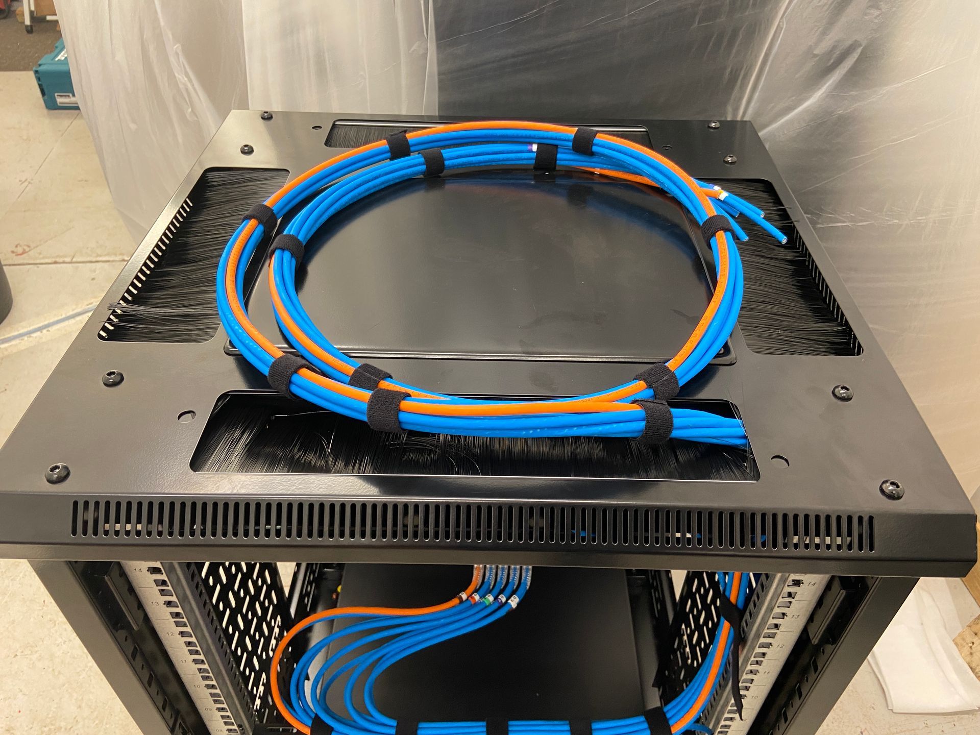 Photo of Patch panel cables looped onto of rack