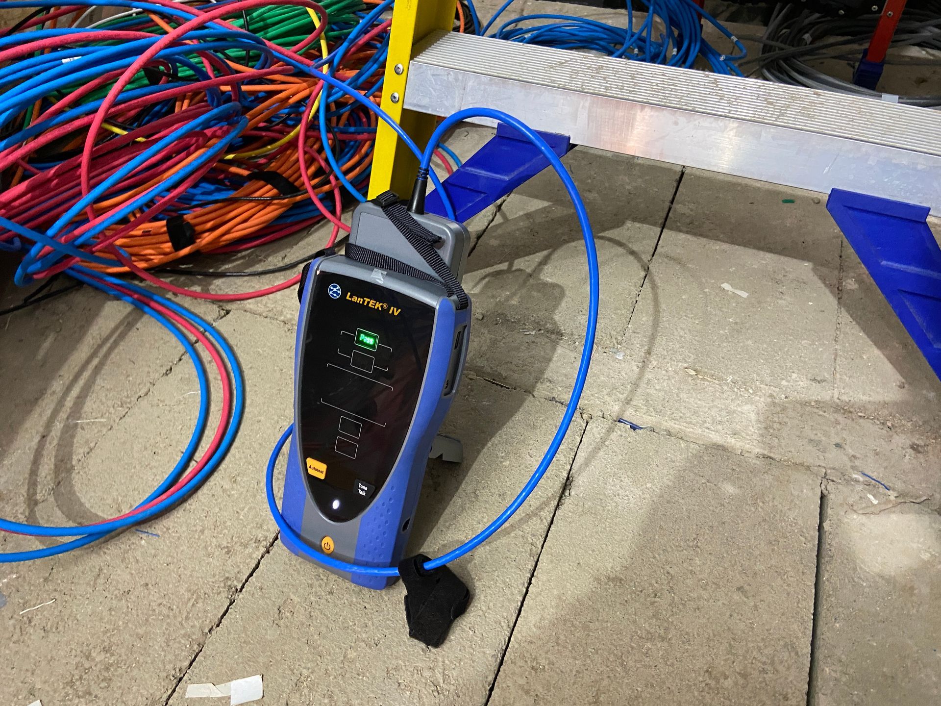 Photo of Verification testing at Head End of CAT6A data cables patch panel ports prior to walls being closed up for plastering
