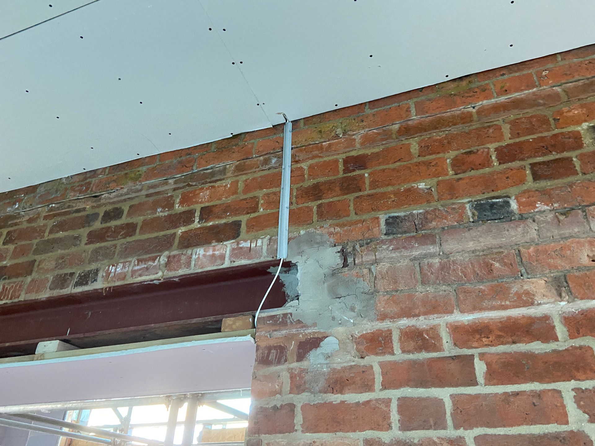 Photo of cable capping to protect cable on section of wall that will have plasterboard attached to it with dot & dab method