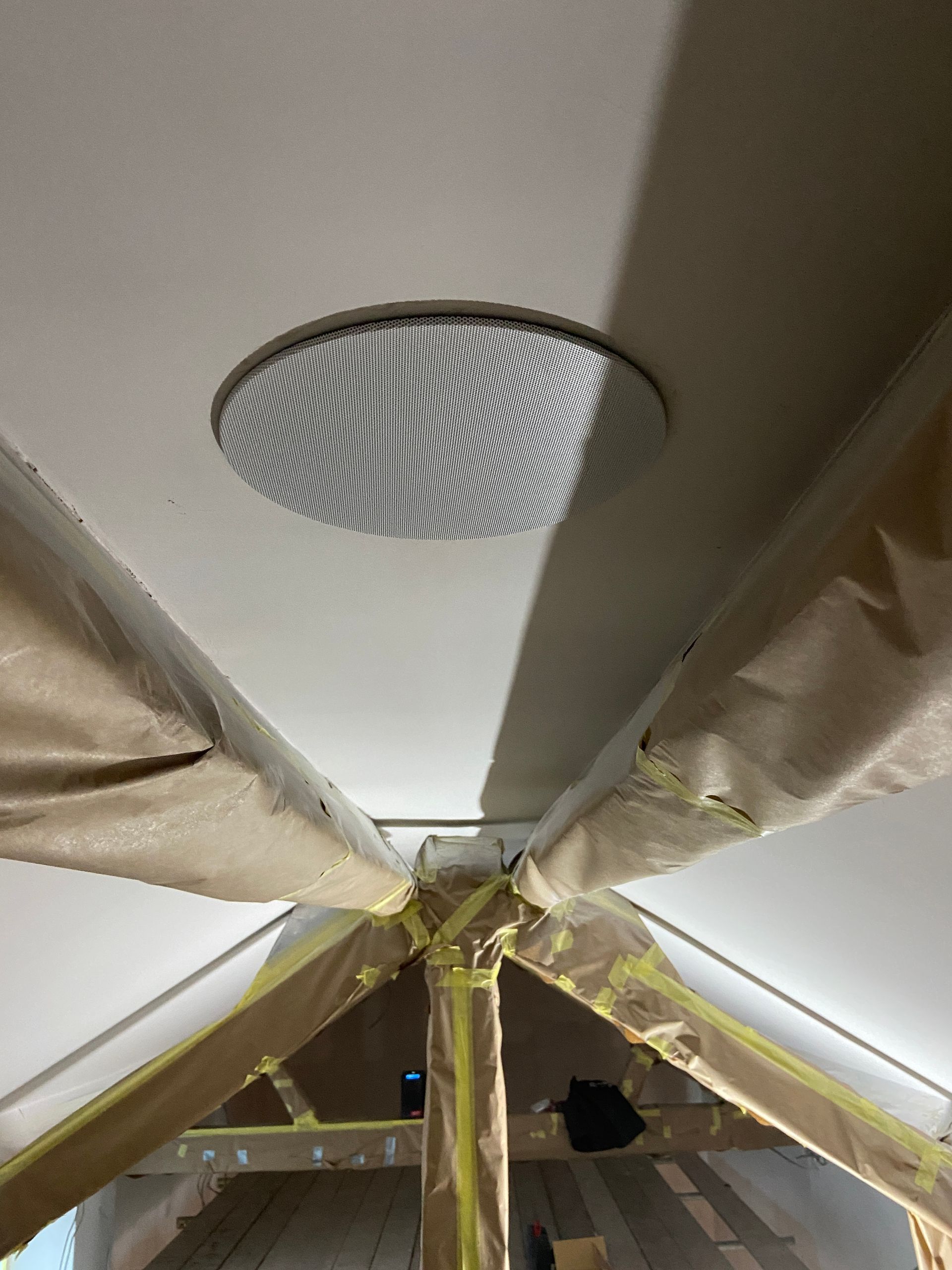 Photo of Speaker installed into ceiling with cover grill