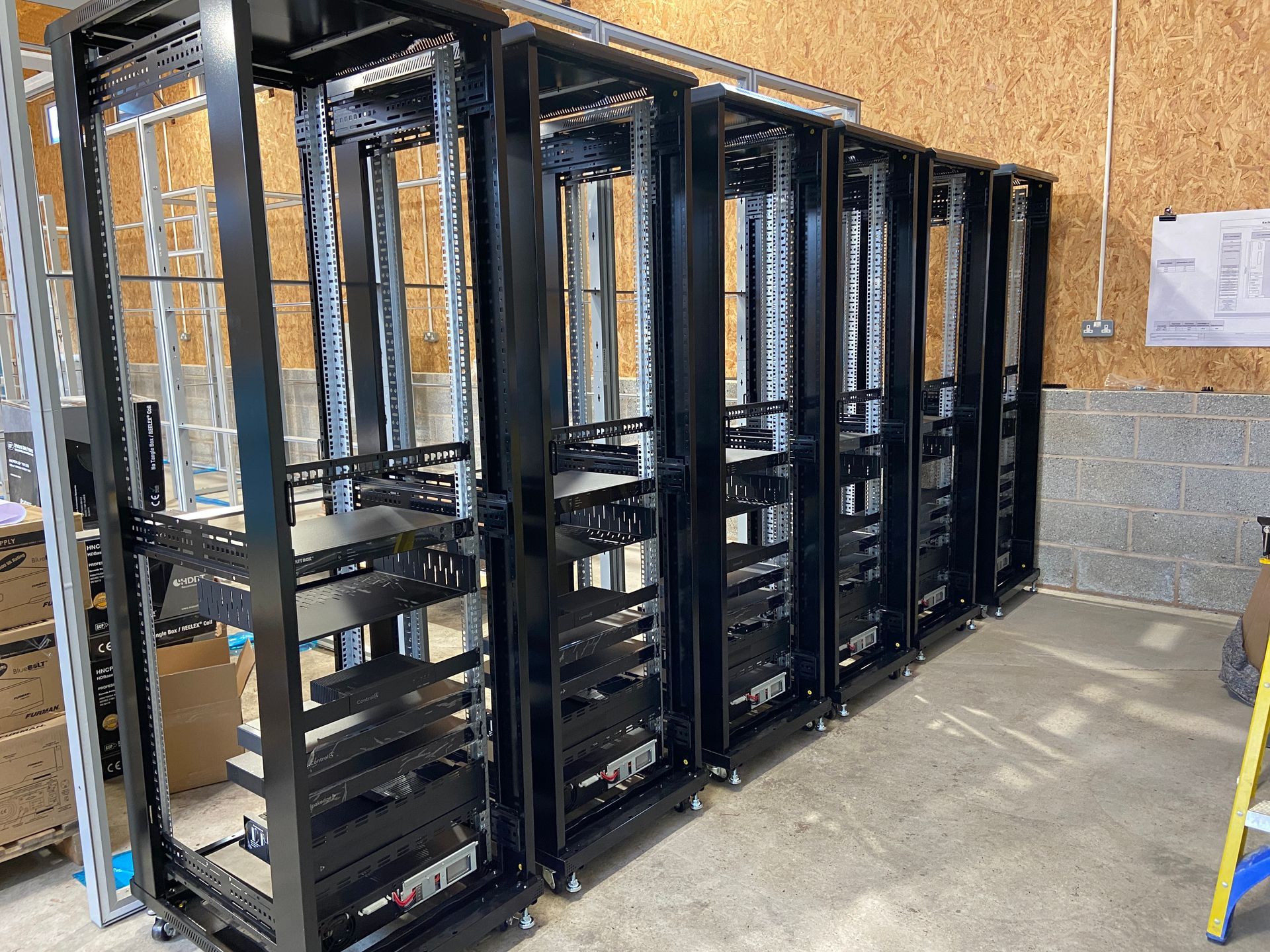 Photograph of equipment being loaded into the 6 racks
