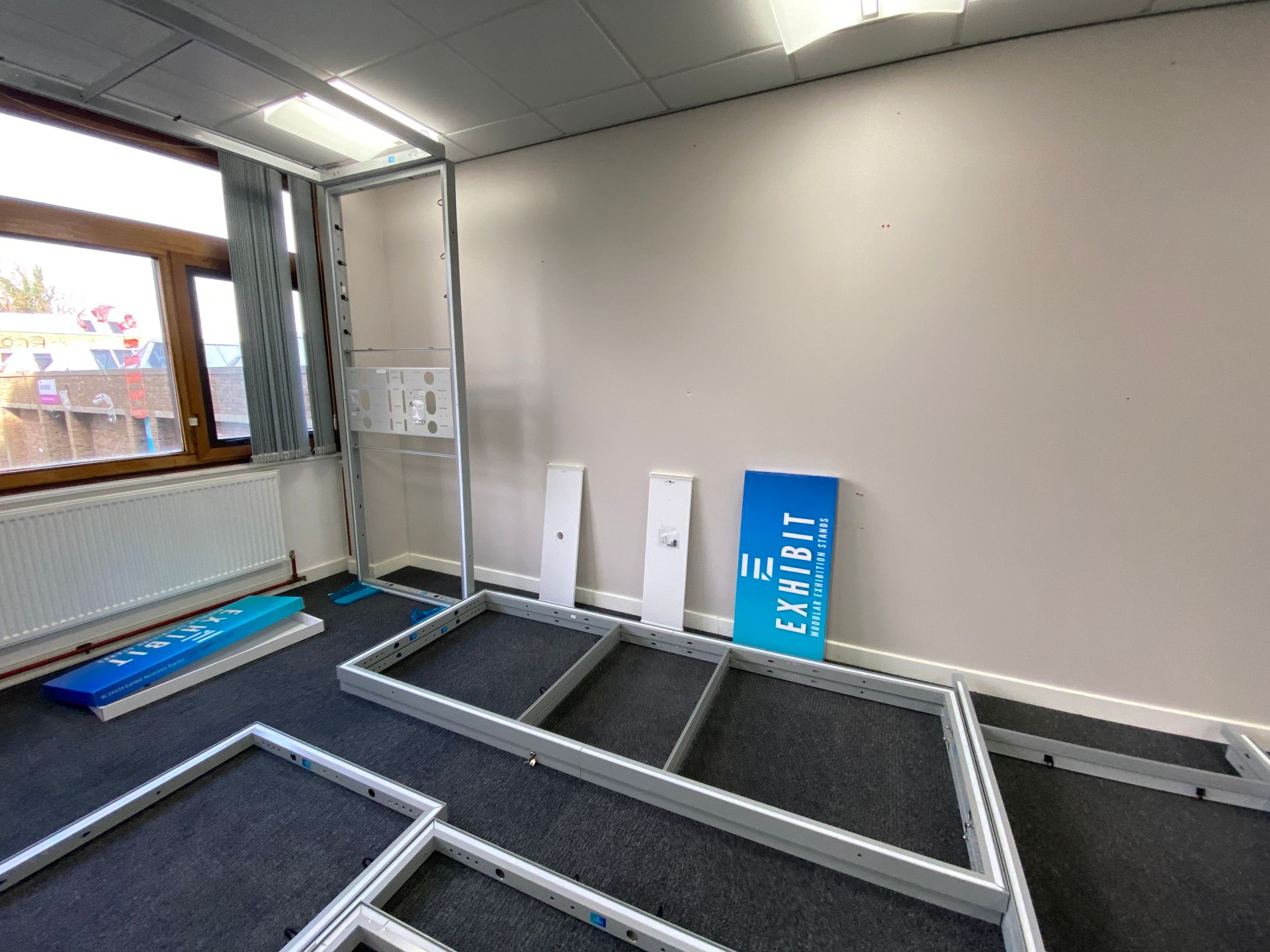 Photograph of exhibition space display system panel reassembly