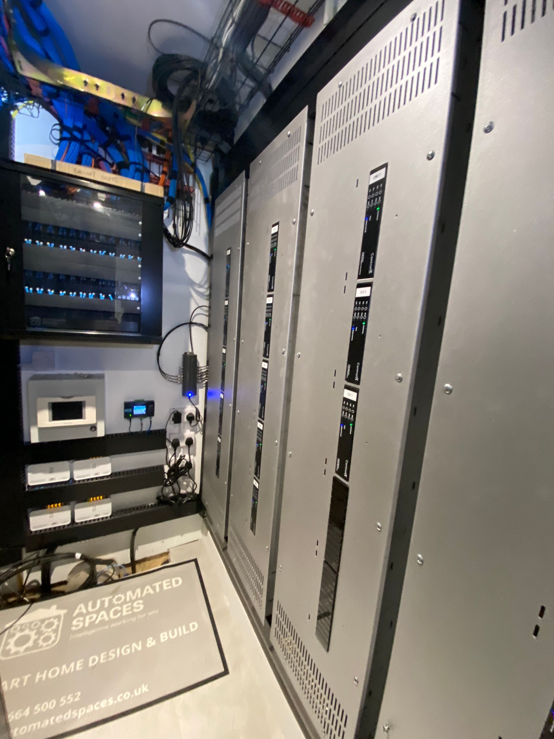 Photo of Patch panel, smart lighting panels, TV antenna splitter, air con control panel, heating integration system, automated blinds communication modules and finger trunking