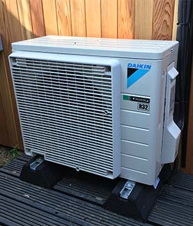 A photograph of an external air conditioning unit that is being controlled by Control4