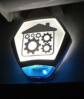 Image of an Intruder Alarm external sounder bell on a house with the Automated Spaces company logo on it