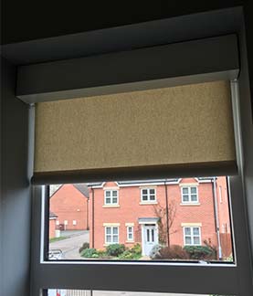 A photograph of a roller blind in a window