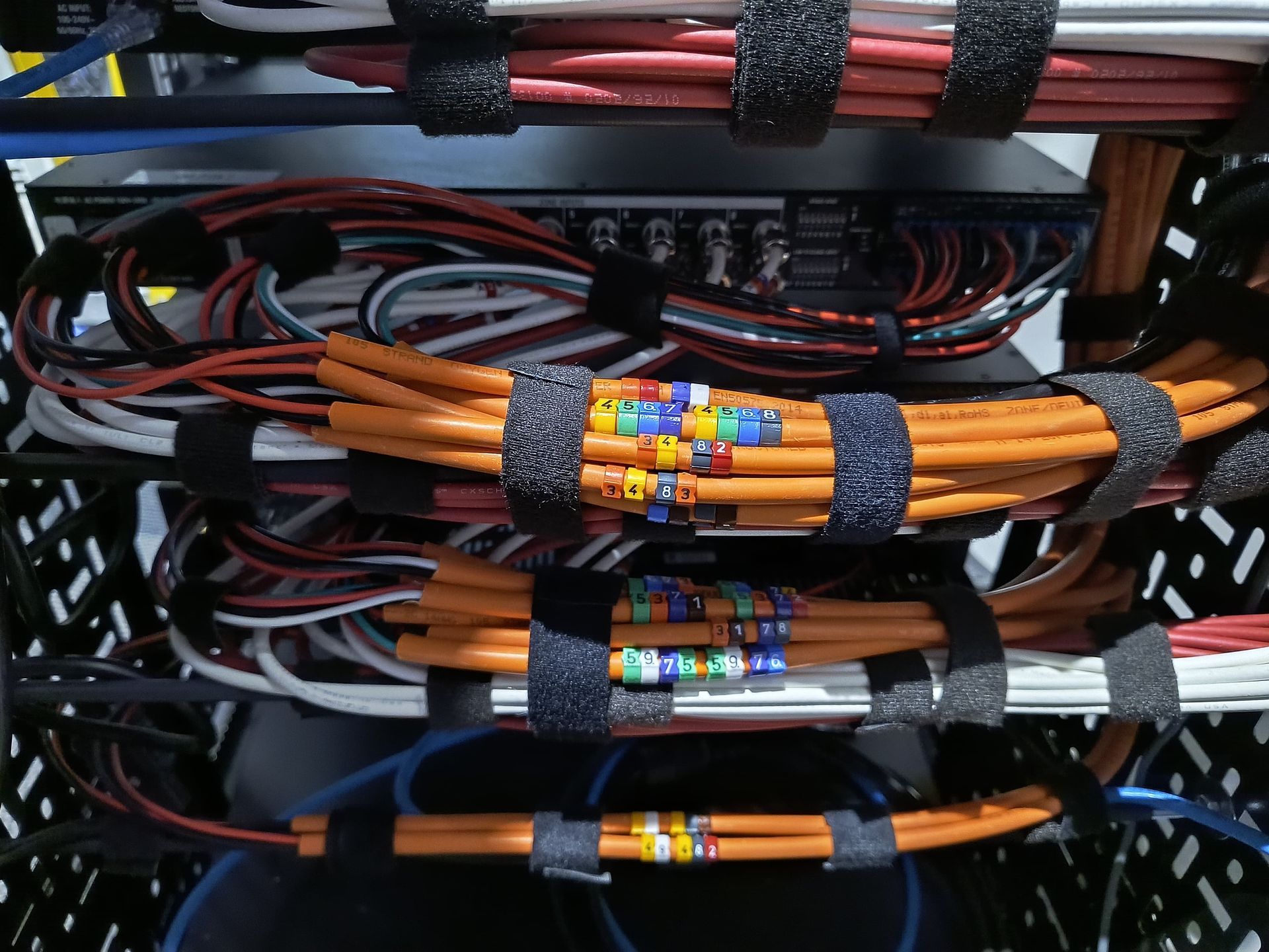 Photo of Speaker cables laced into server with cable label indentification markers