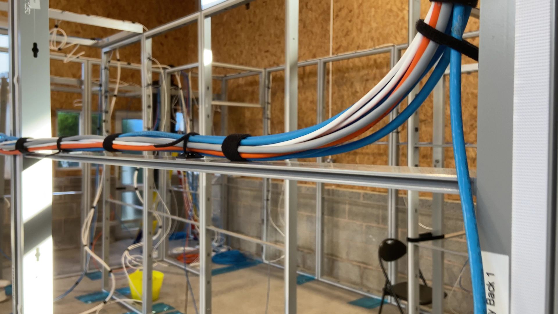 Photograph of non-power cable loom attached to exhibition display system panels