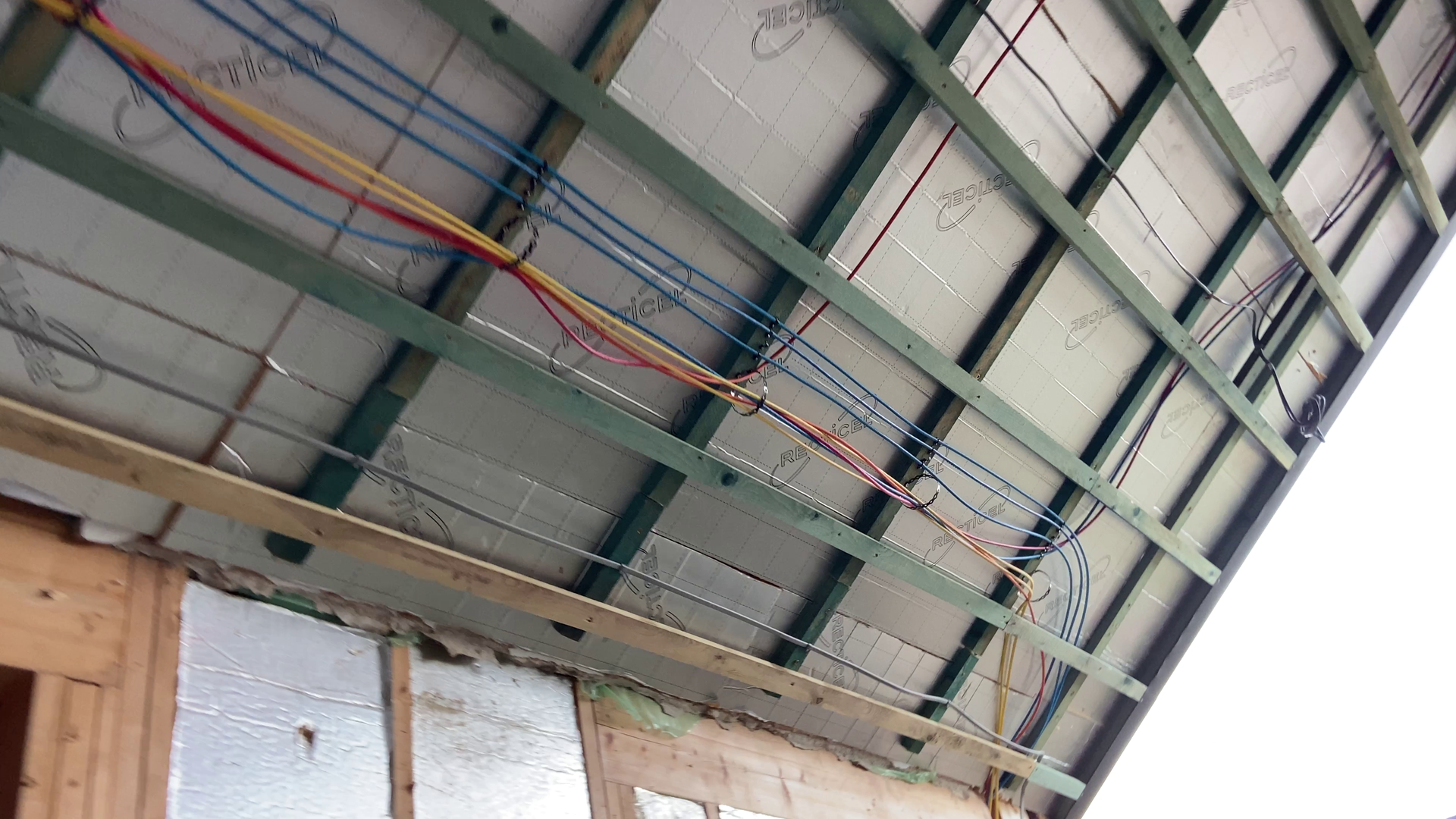 Photo of CAT6A Data and Smart Lighting Cables attached to ceiling battens prior to being plaster boarded