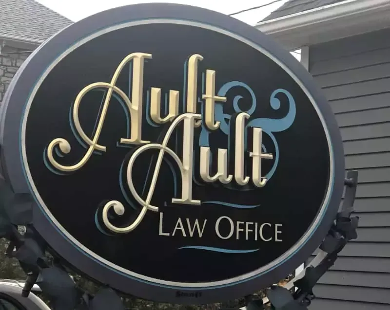 A sign that says ault & ault law office on it