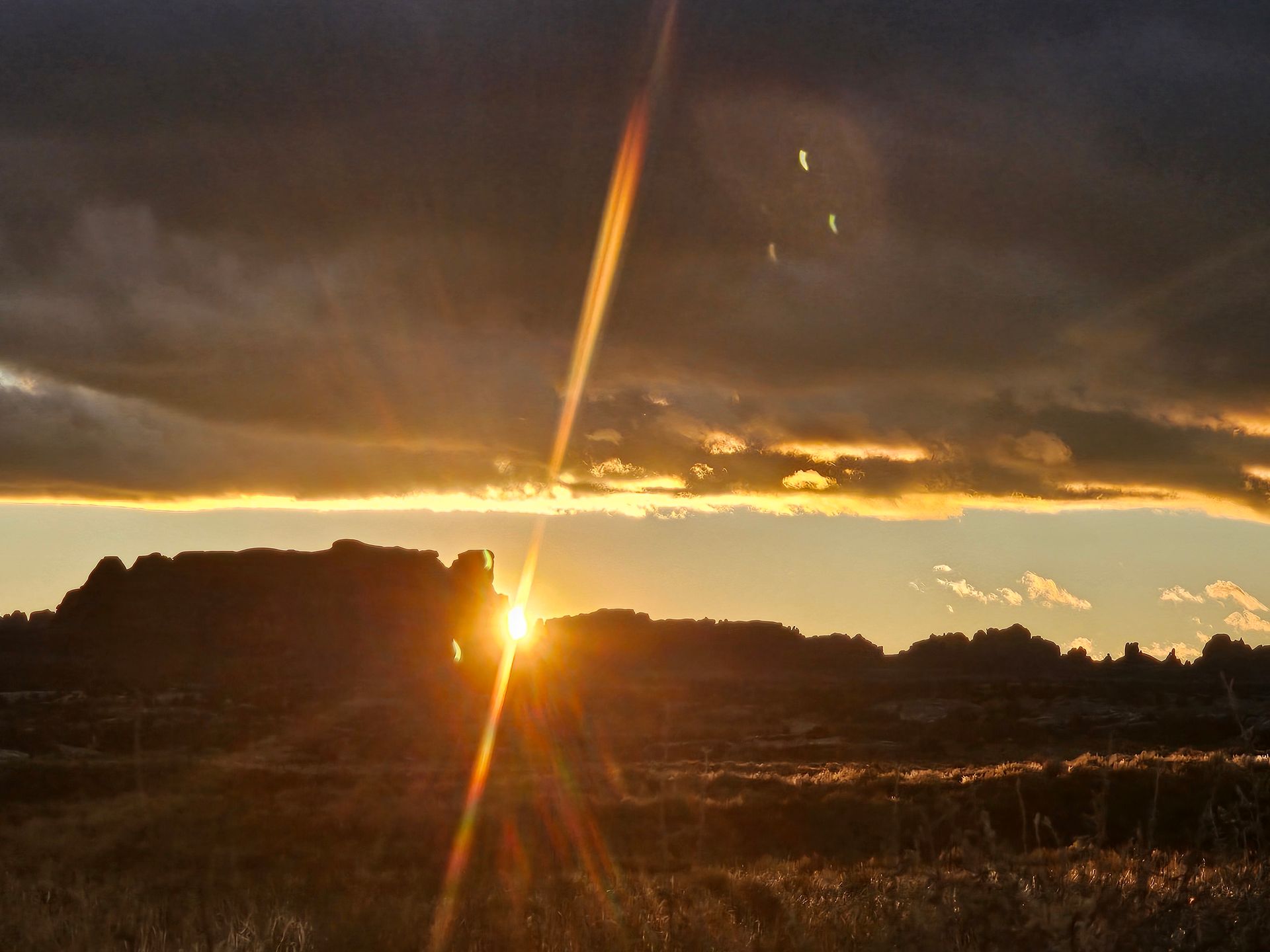 The sun is setting over a desert landscape
