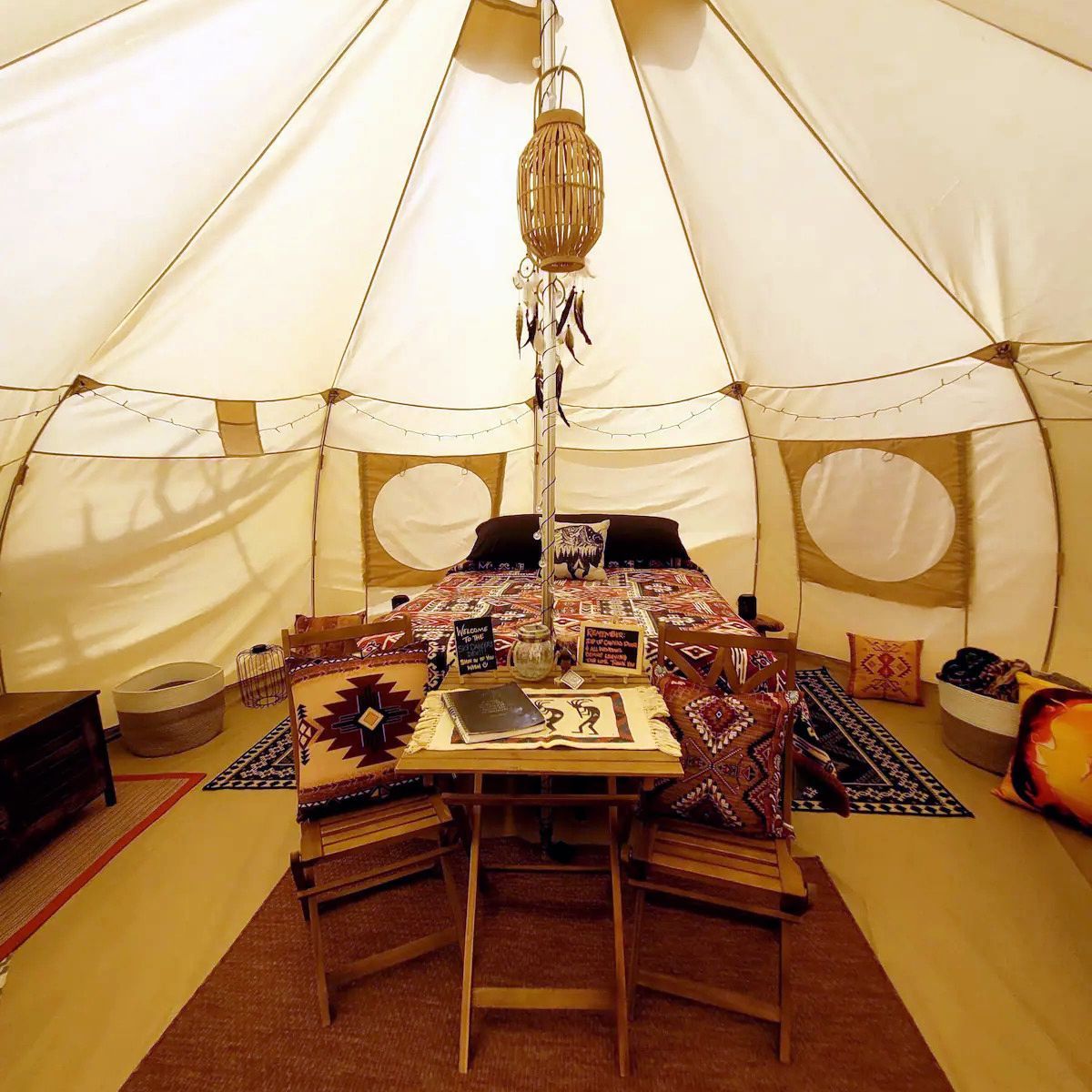 A tent with a table and chairs inside of it