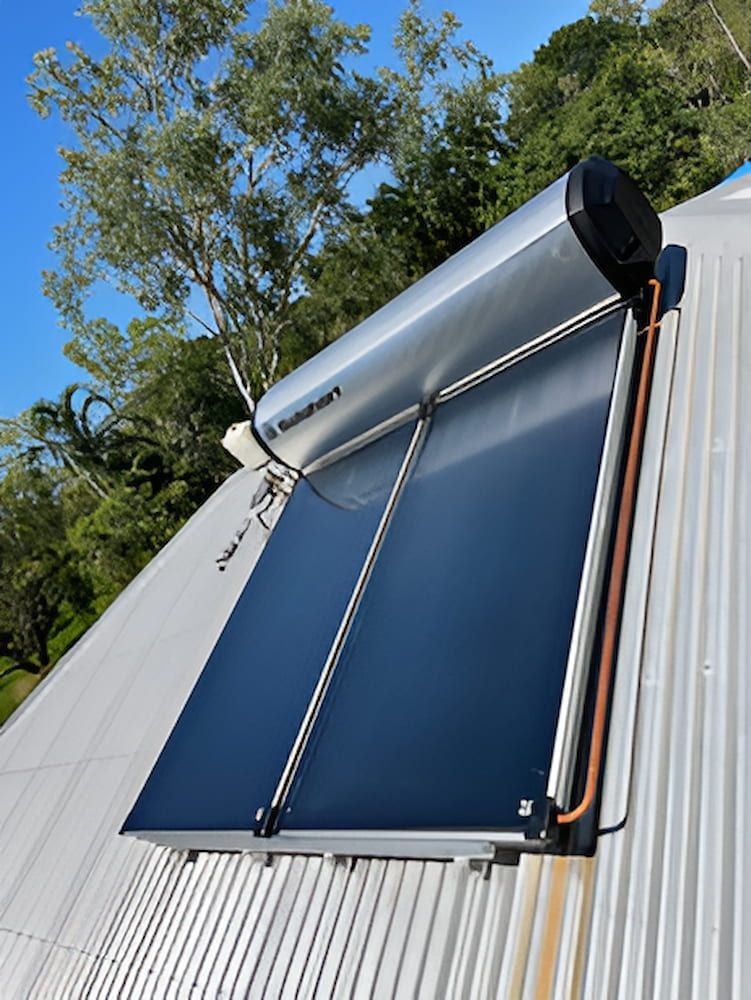 A Solar Water Heater Is Mounted On The Roof Of A Building — DAVMAC Plumbing in Wauchope, NSW