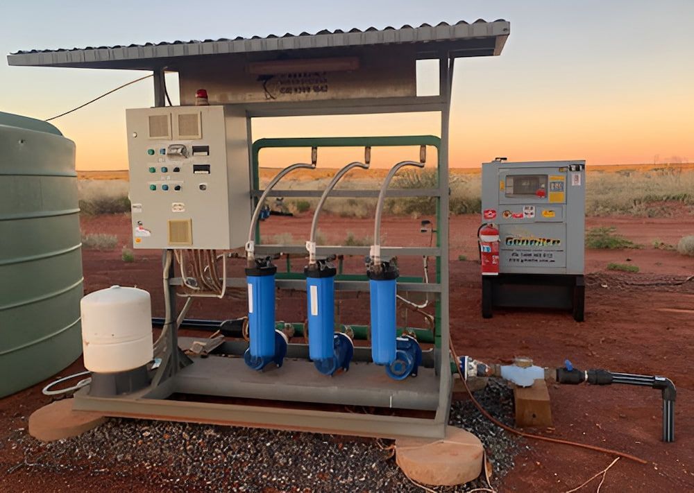 A Water Pump Is Sitting Under A Roof In The Desert — DAVMAC Plumbing in Wauchope, NSW