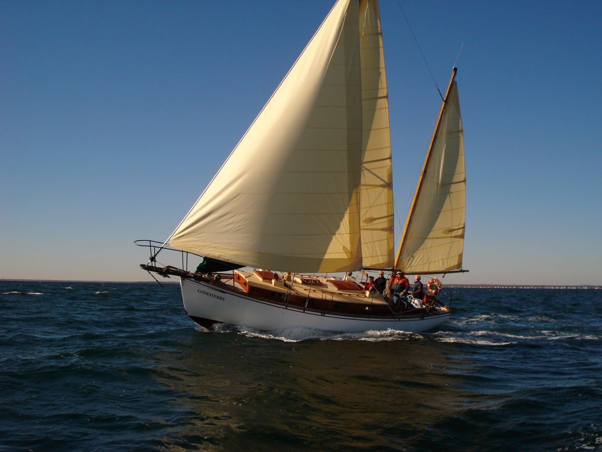A sailboat is floating on top of a large body of water