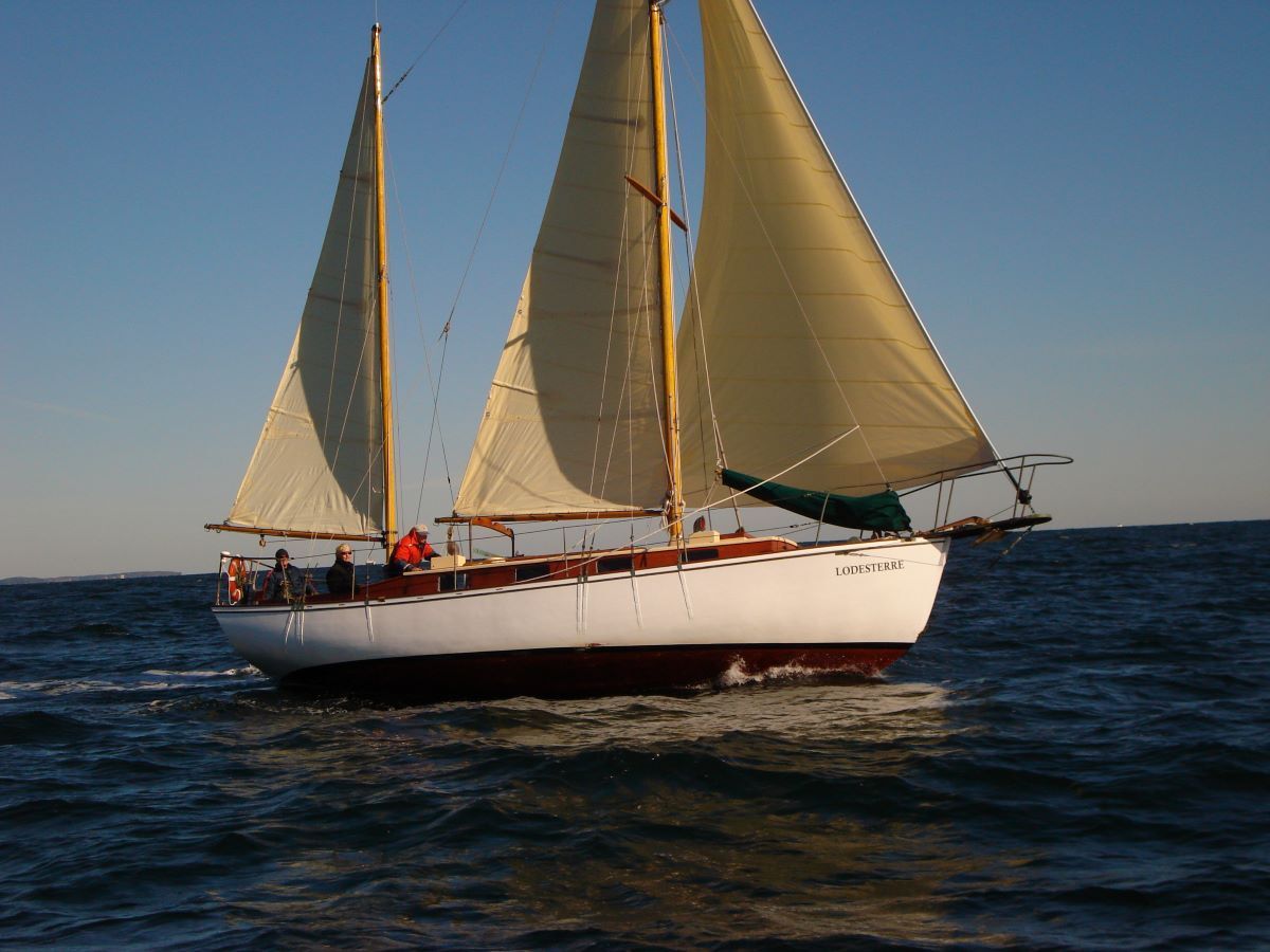 A sailboat is floating on top of a large body of water