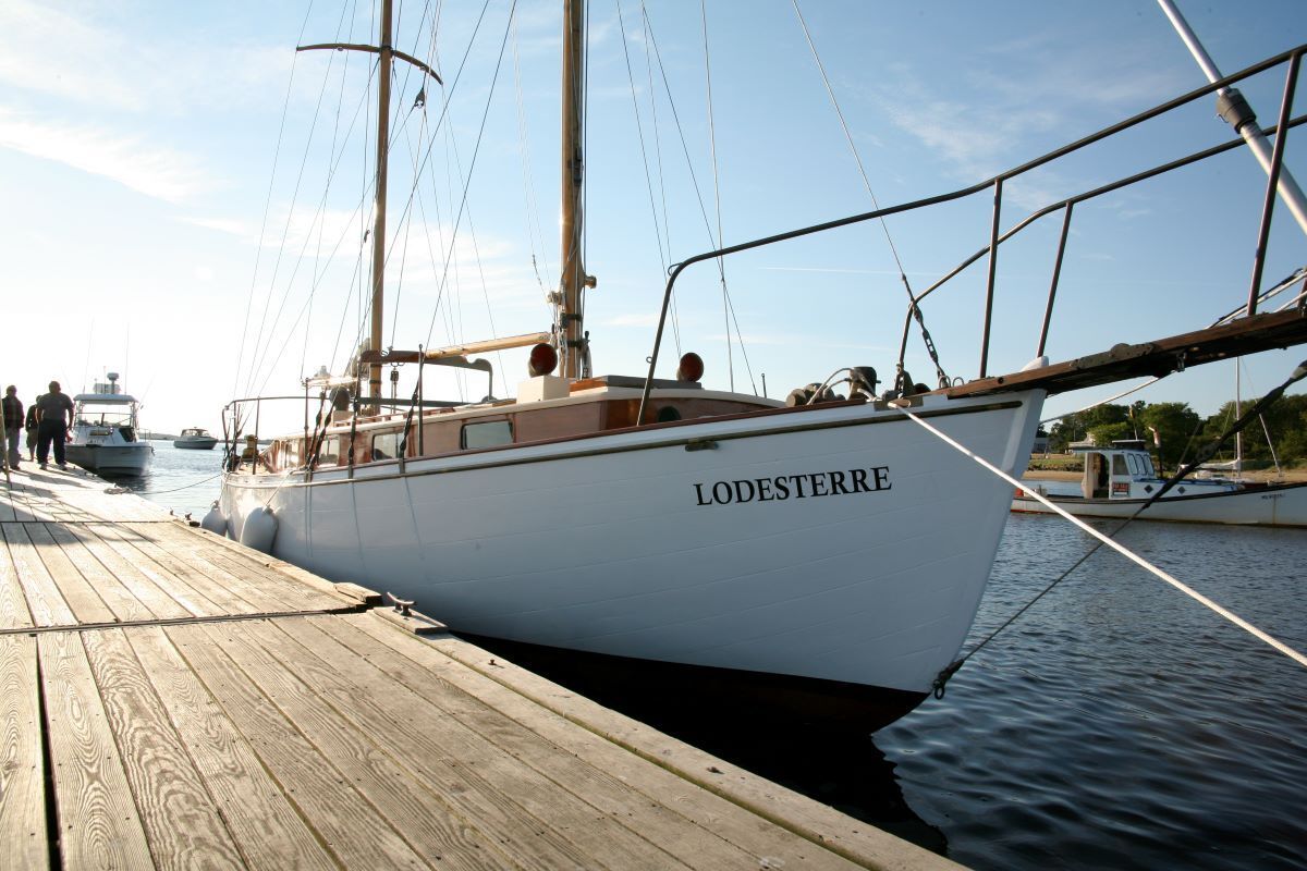 A boat named lobesterre is docked at a dock