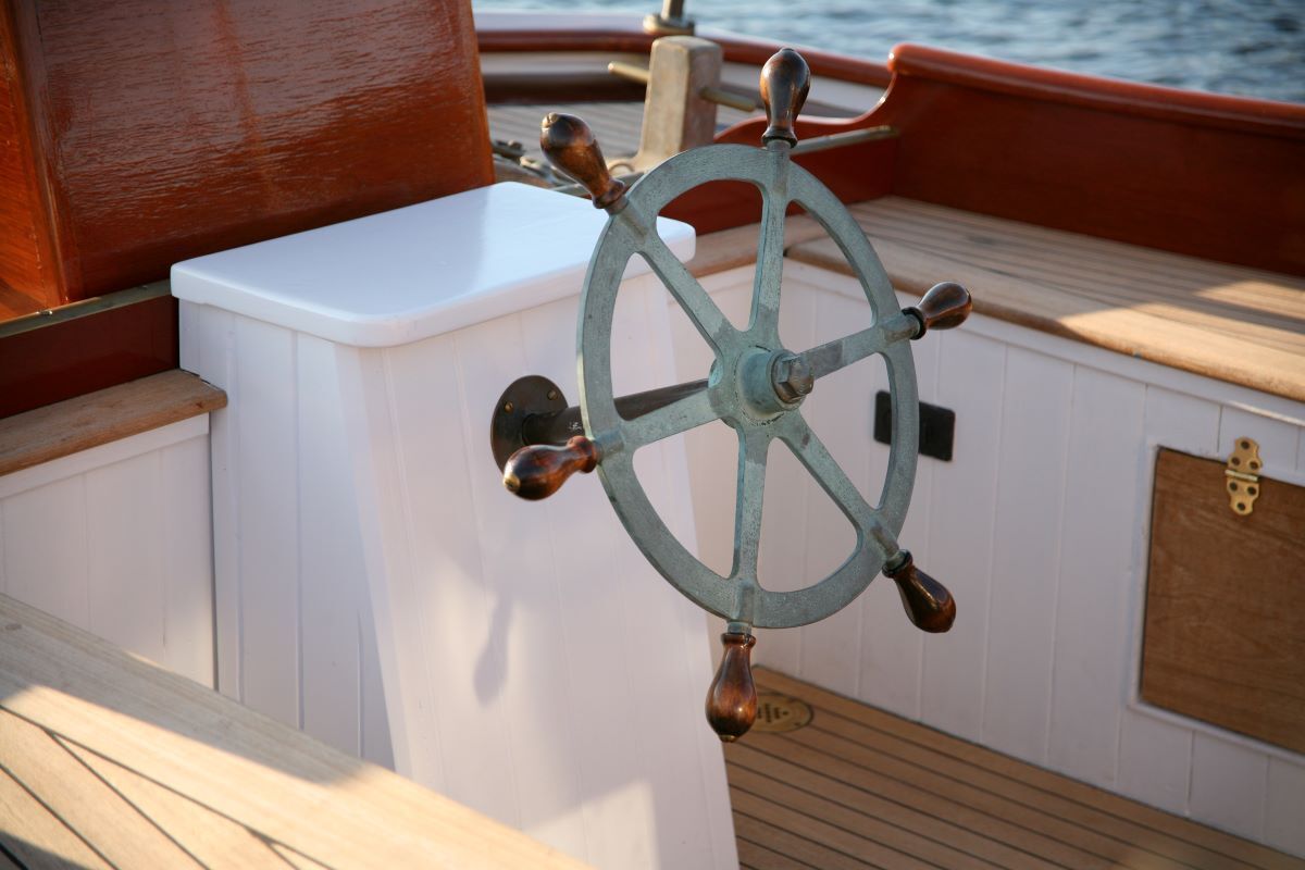 A close up of a steering wheel on a boat
