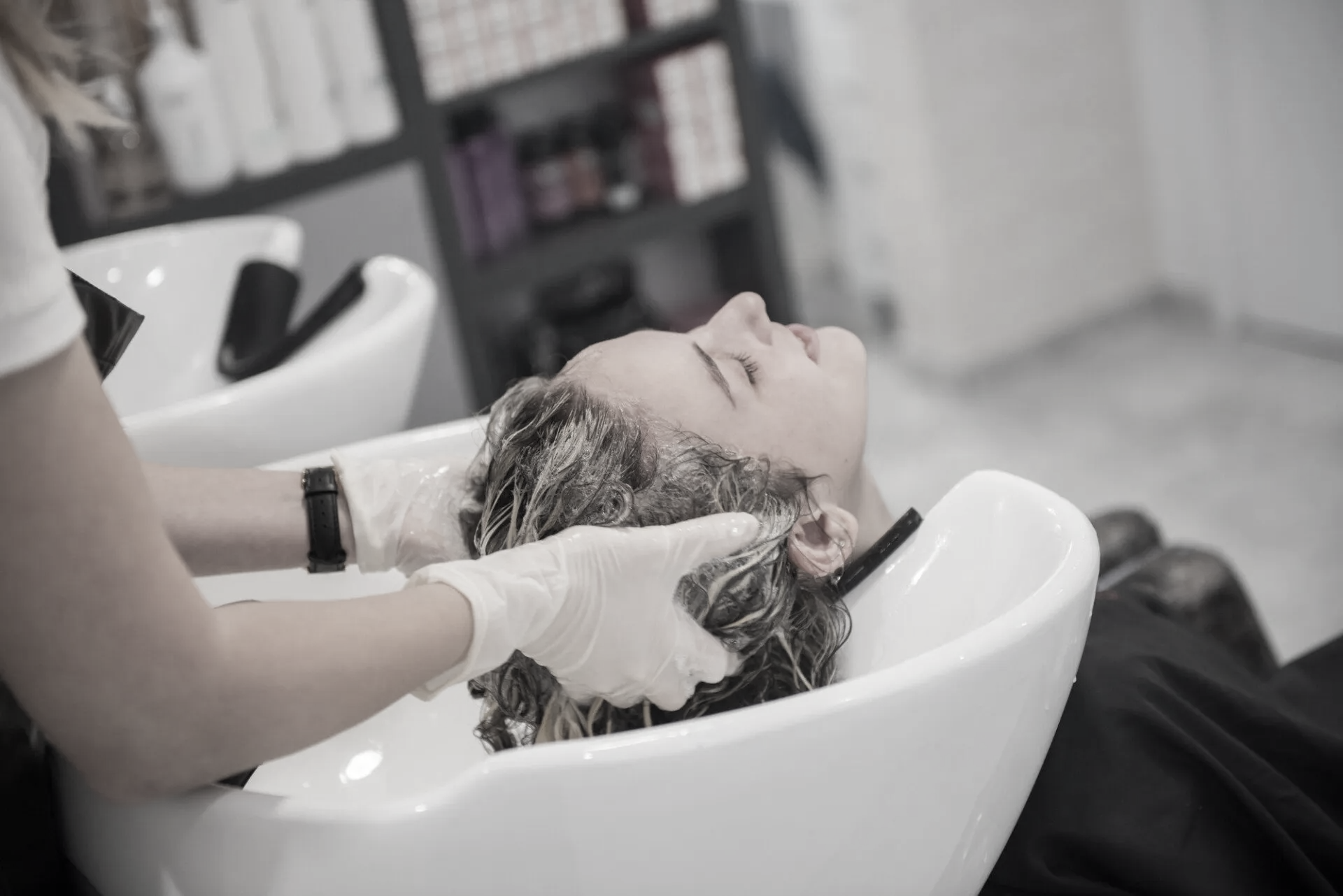 woman in salon having her hair washed