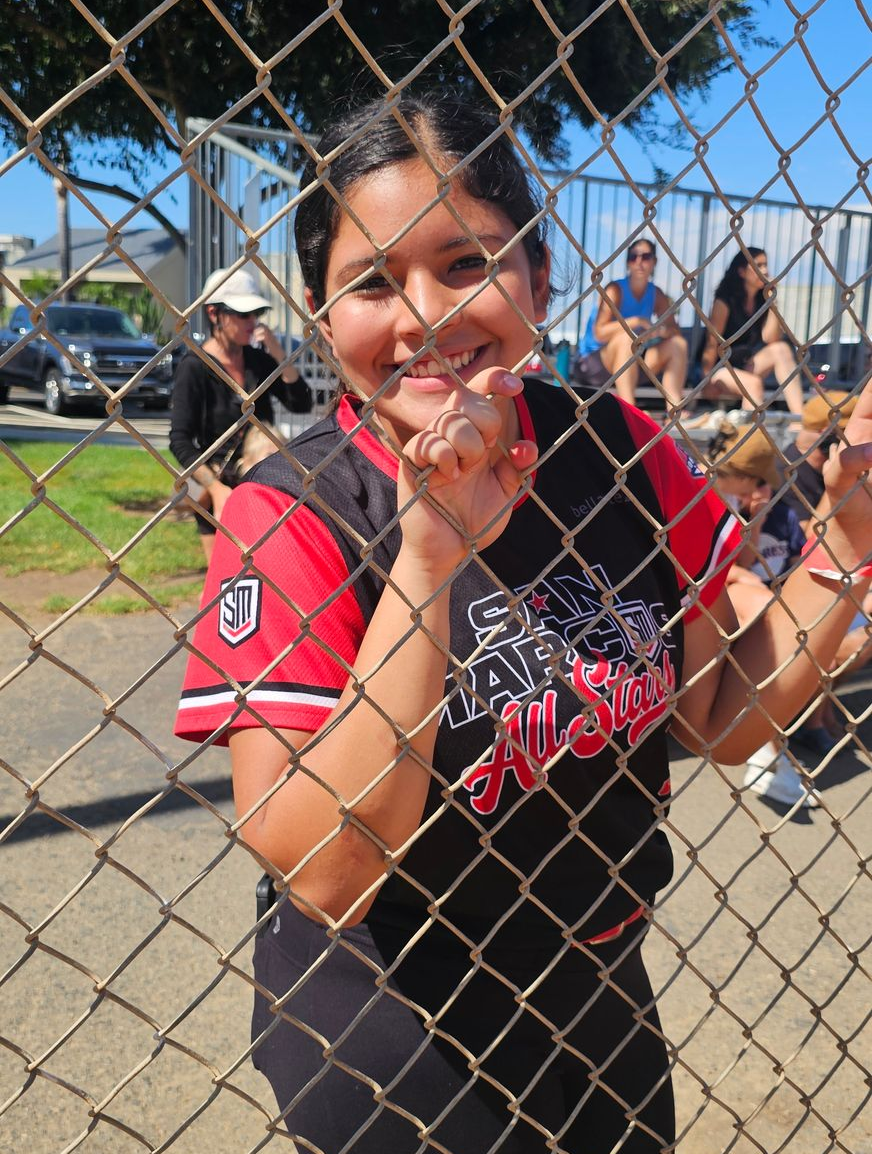 Baseball on a dark surface, with visible stitching.