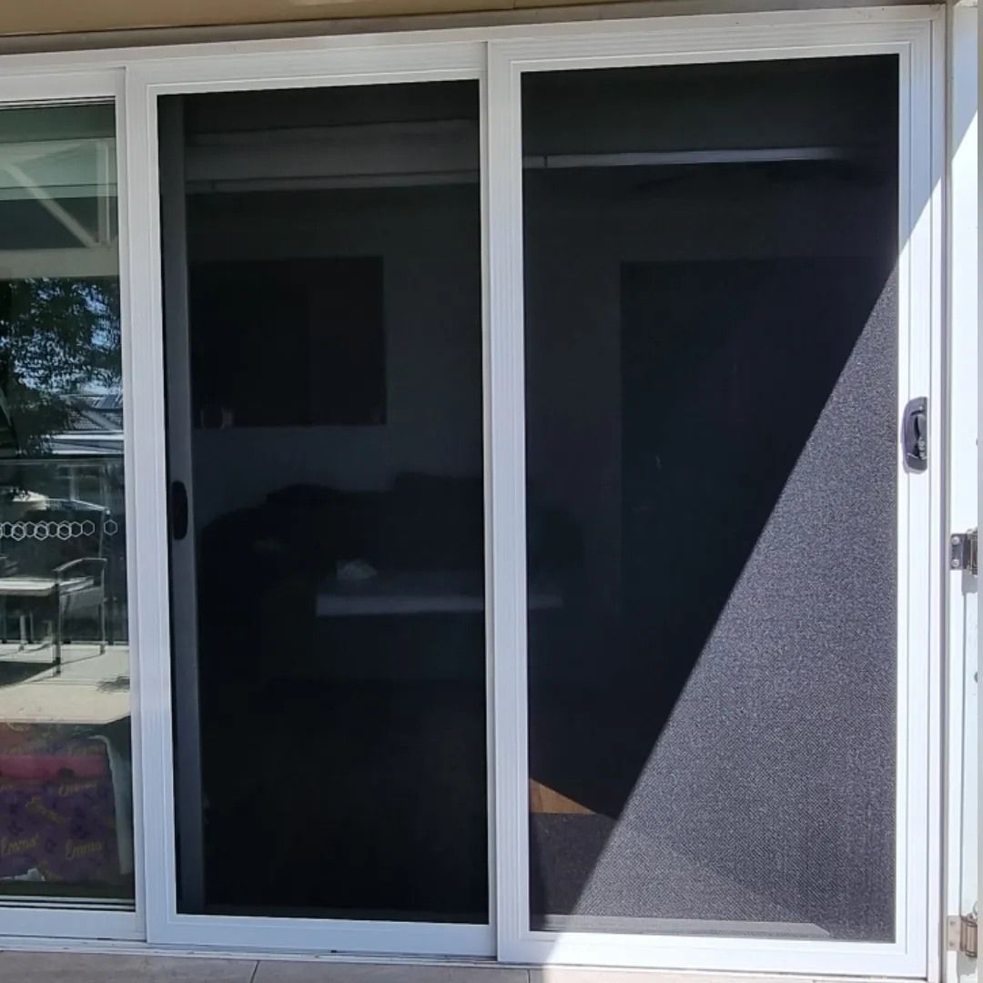 A sliding glass door with a screen on it