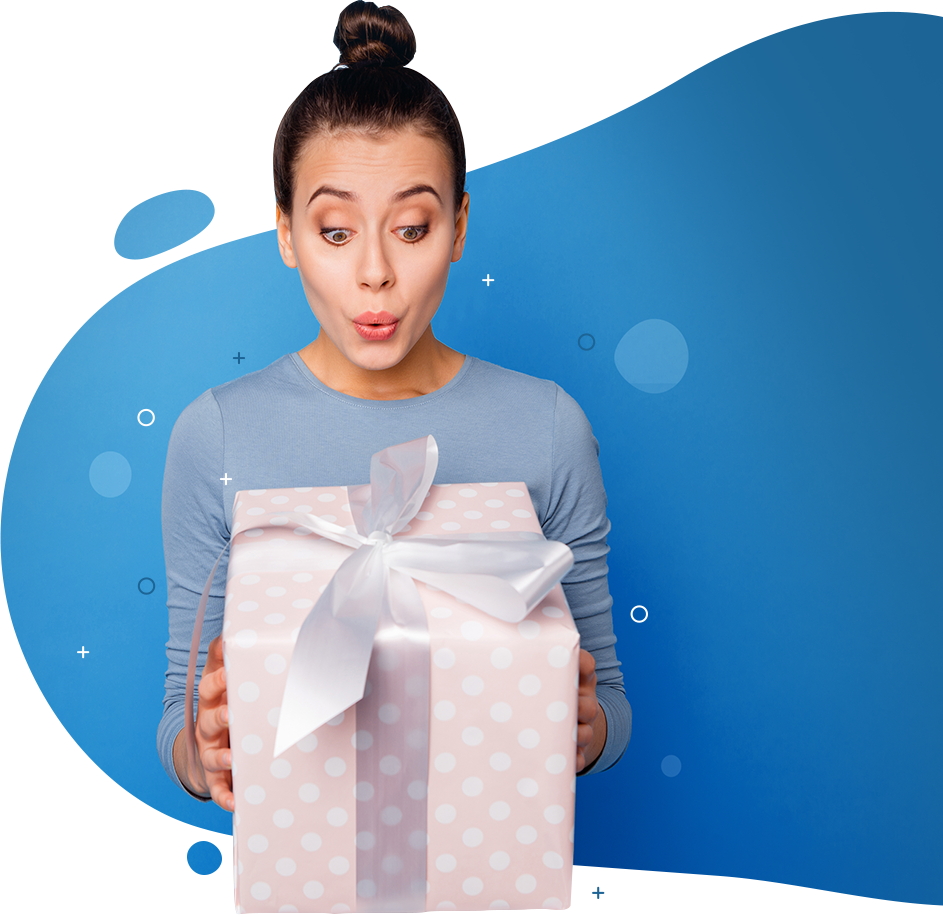 A woman is holding a pink gift box with a white bow.