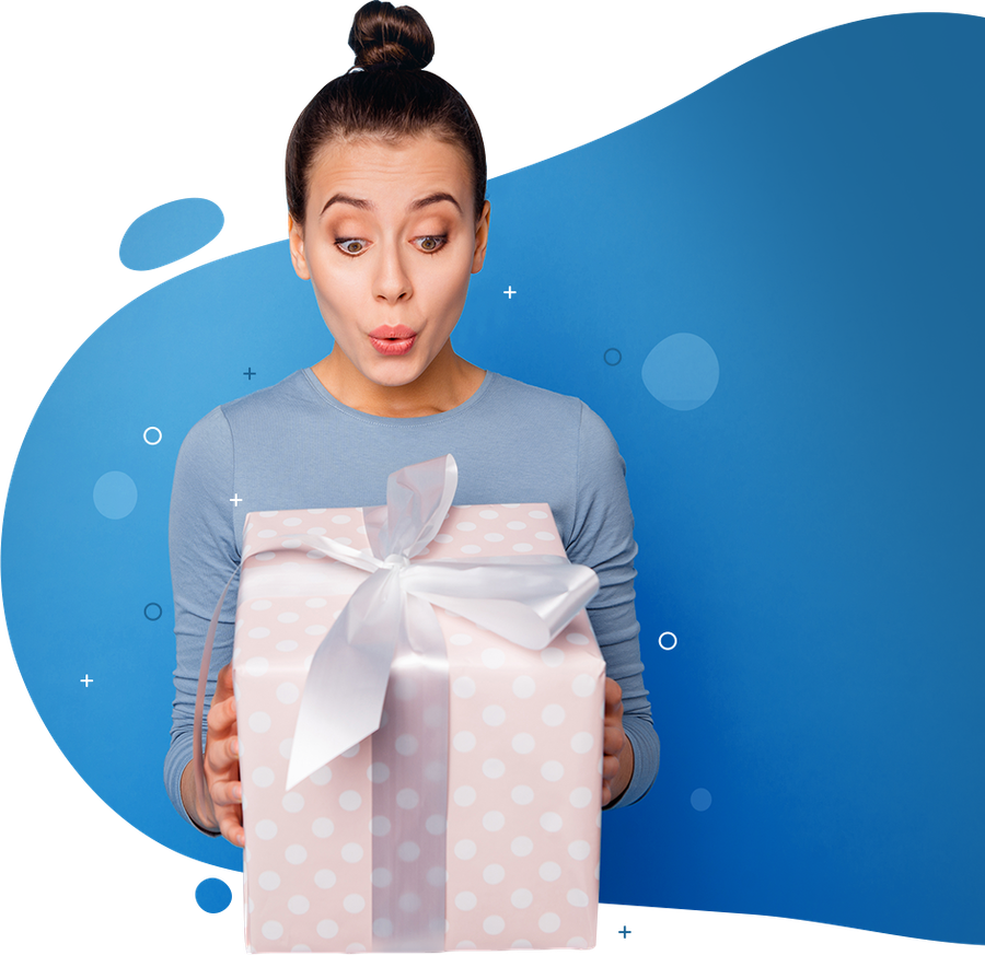 A woman is holding a pink gift box with a white bow.