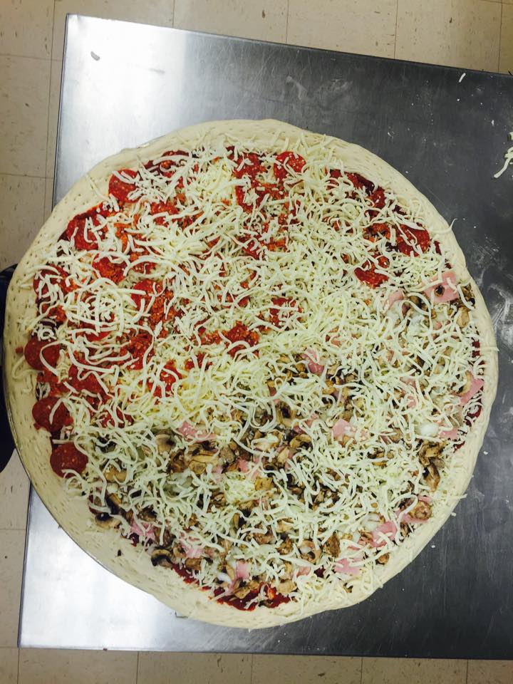 A pizza with tomato sauce and cheese on it