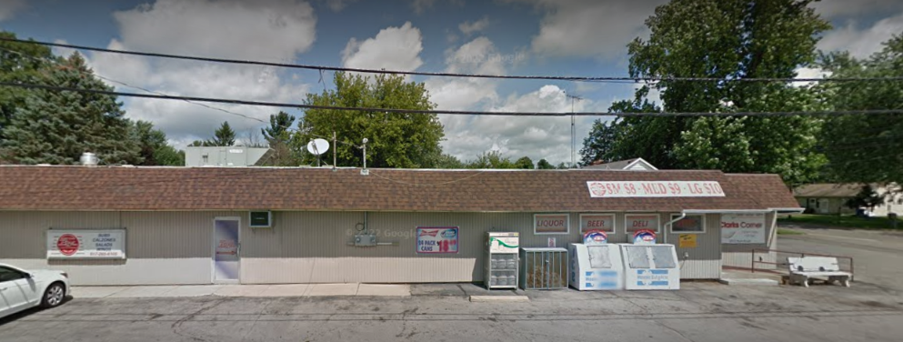 A small store with a car parked in front of it.