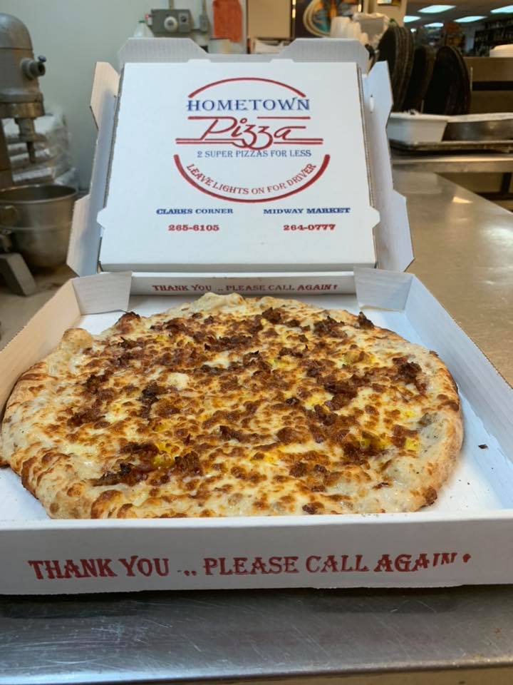 A pizza in a box that says hometown pizza