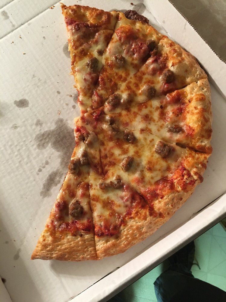 A pizza with a slice missing is in a box
