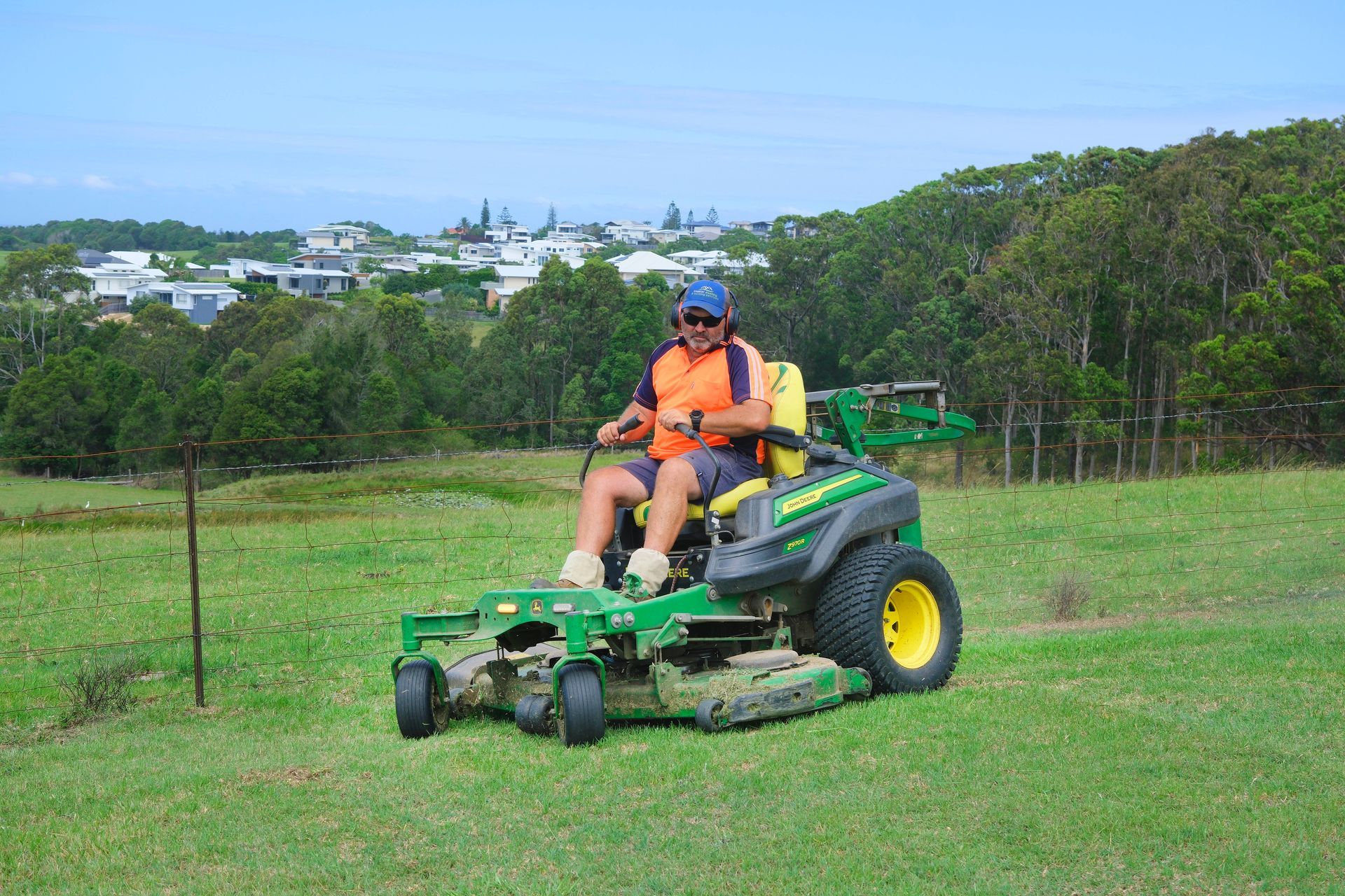 A Person Wearing a Bright Orange Shirt — Coastal Slashing & Mowing Services In Tallwoods Village, NSW