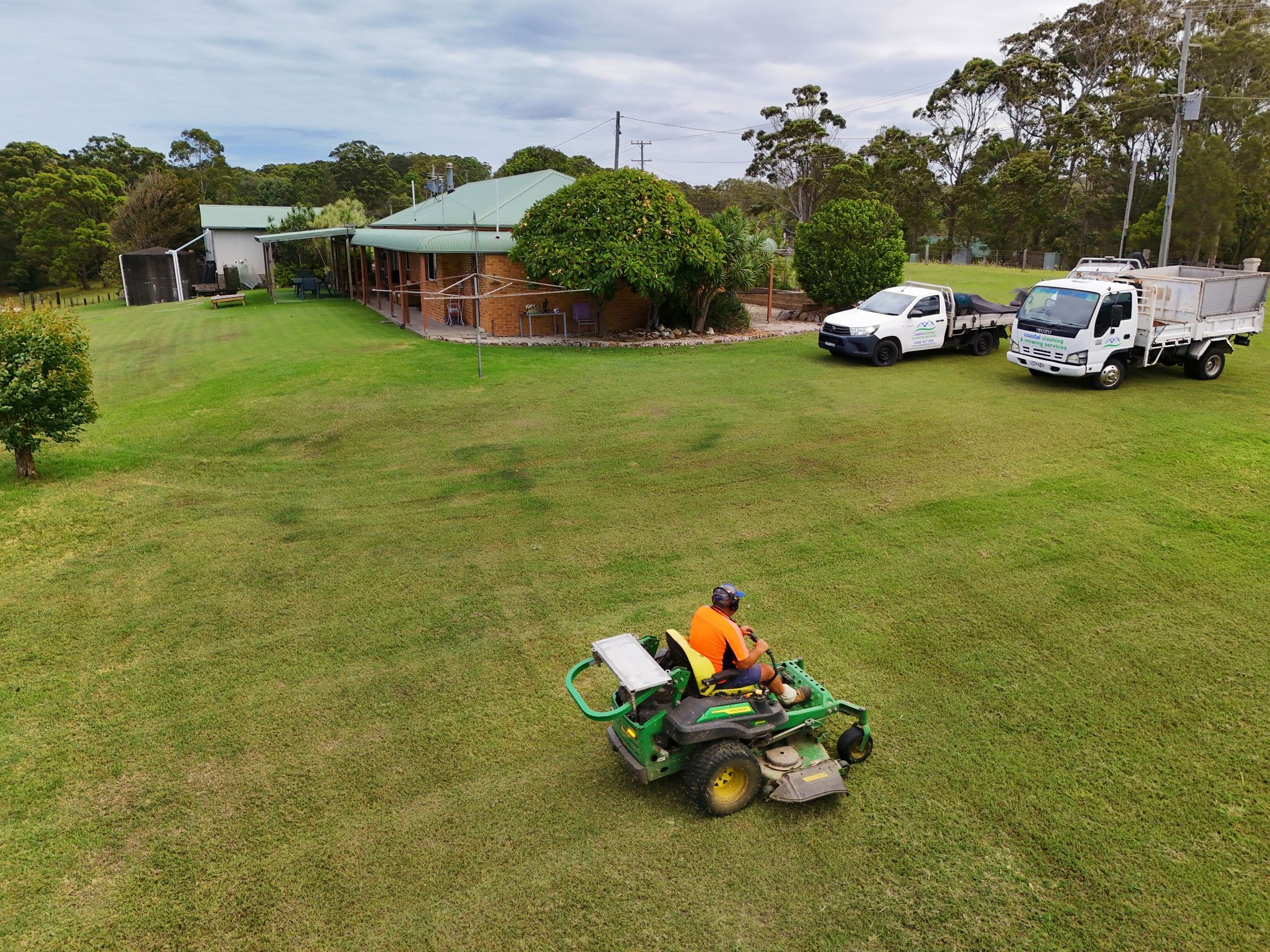 Two People Laying Sod in a Residential Front Yard — Coastal Slashing & Mowing Services In Tallwoods Village, NSW