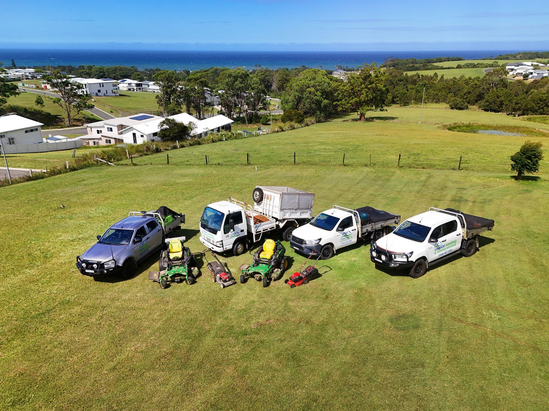 An Aerial View of a Landscaping Crew’s Vehicles and Lawn Mowers — Coastal Slashing & Mowing Services In Harrington, NSW