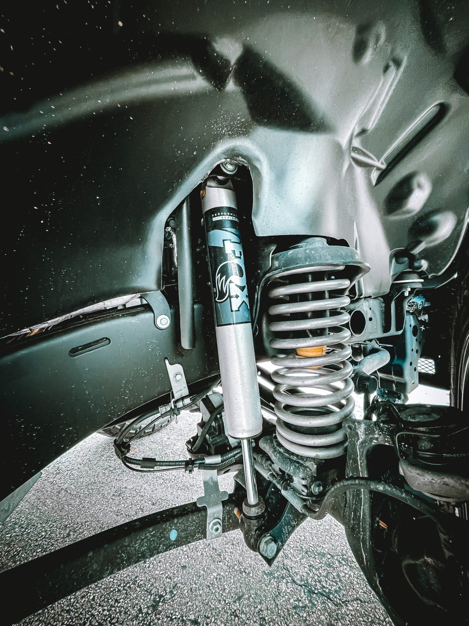 A close up of a shock absorber on a truck. | CB Wheels & Tires, 4x4, Suspension, Center