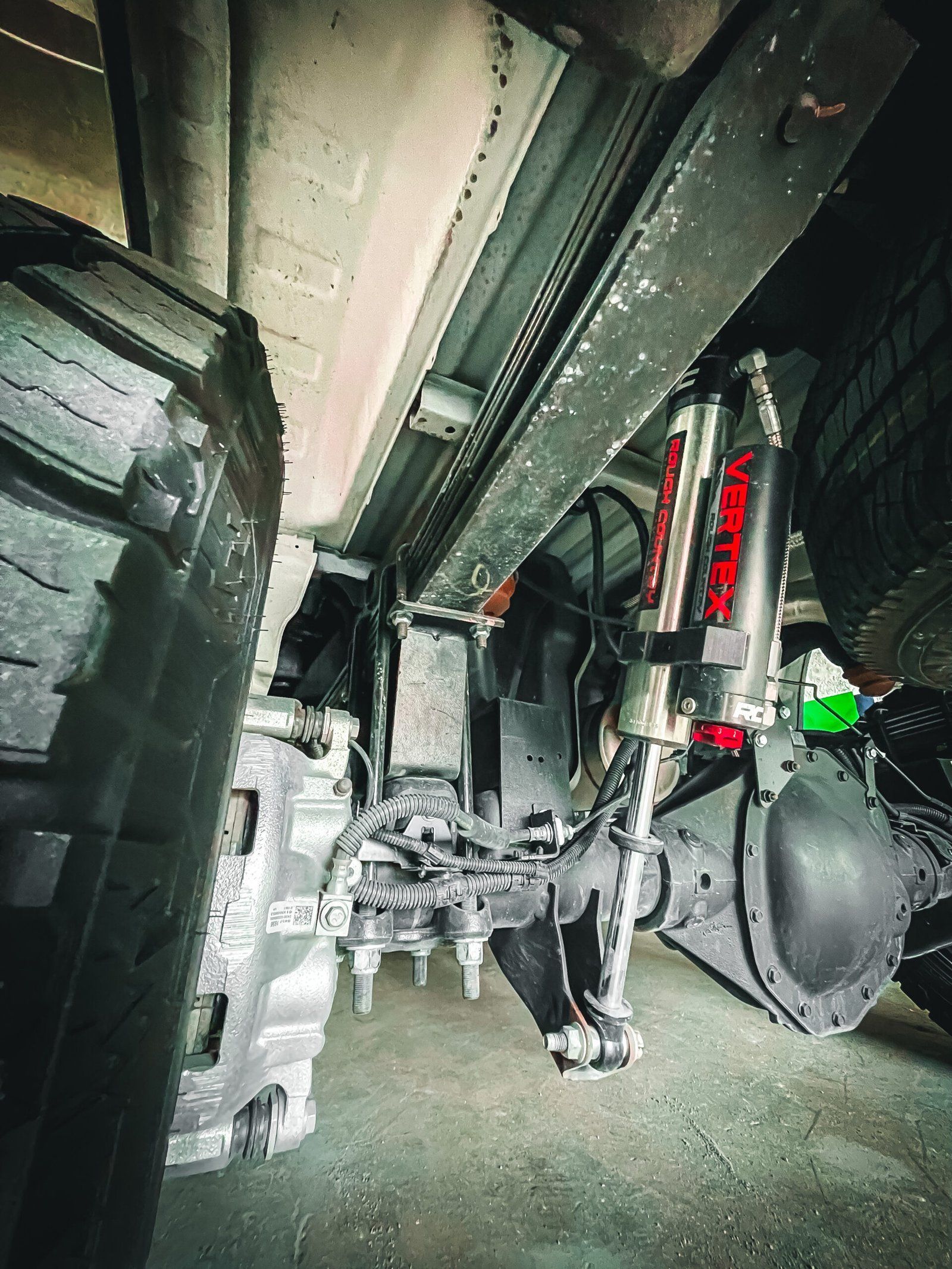 A close up of the underside of a truck 's suspension system. | CB Wheels & Tires, 4x4, Suspension, Center