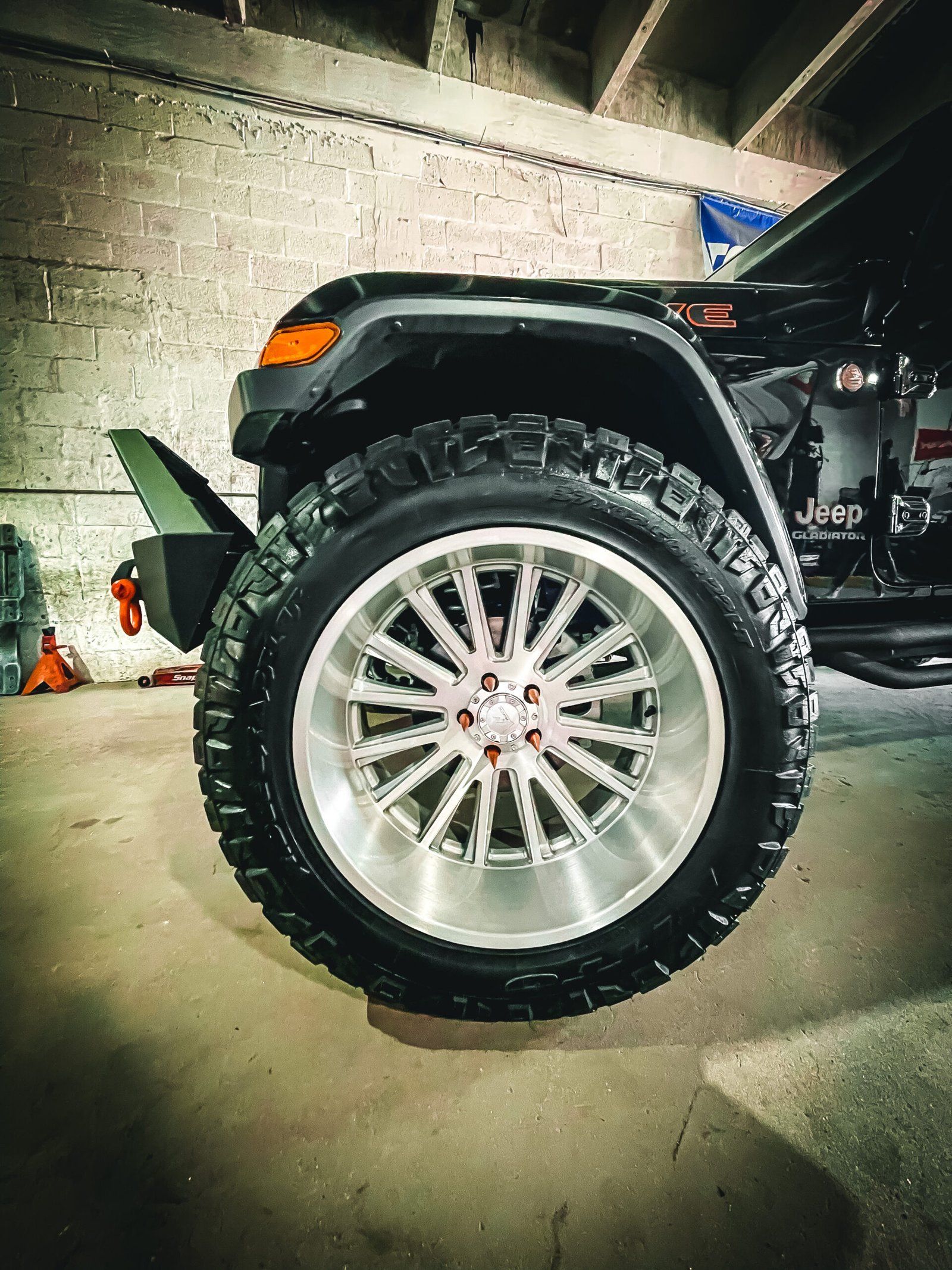 A close up of a jeep wheel in a garage. | CB Wheels & Tires, 4x4, Suspension, Center