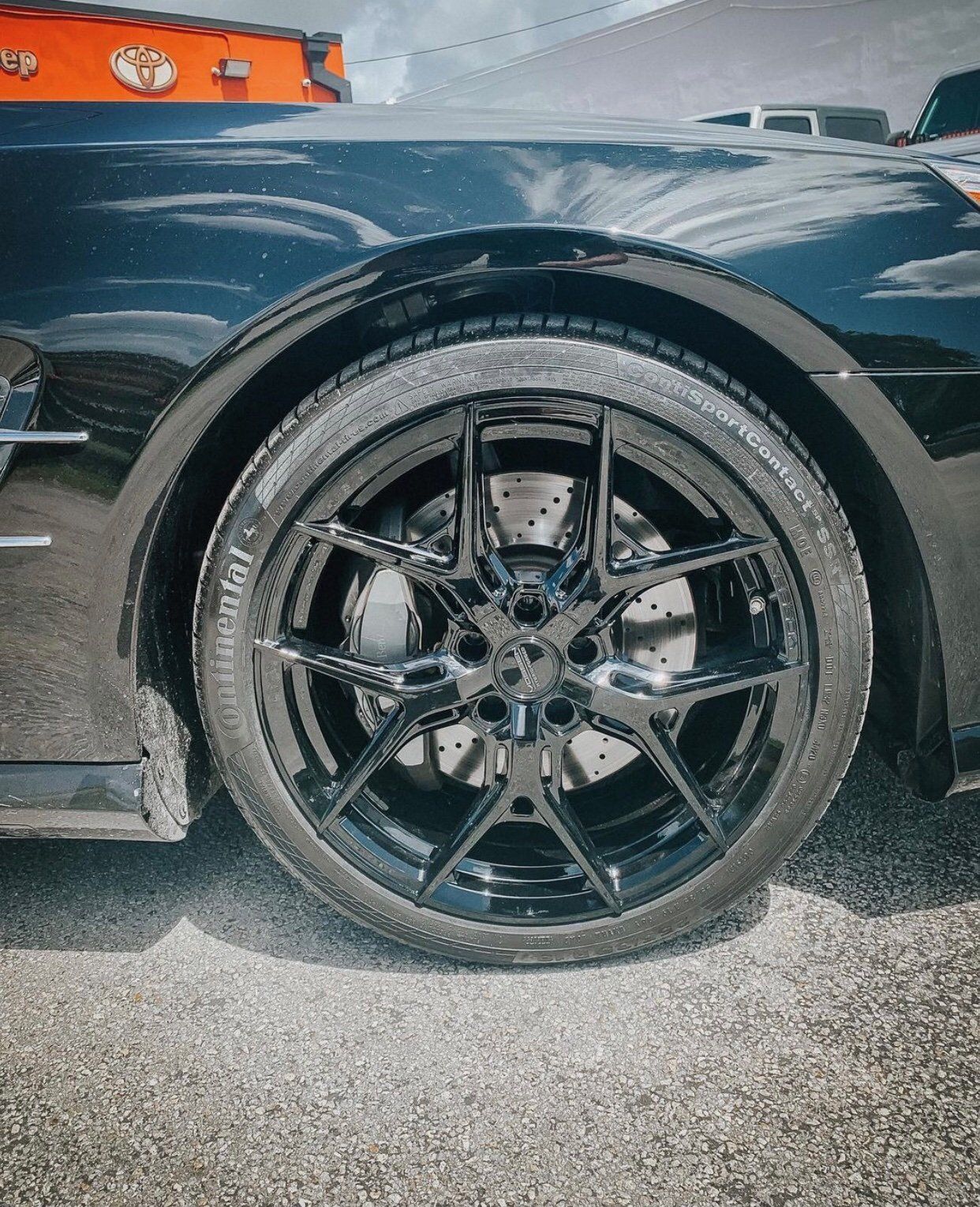 A close up of a black car 's wheel and tire. | CB Wheels & Tires, 4x4, Suspension, Center