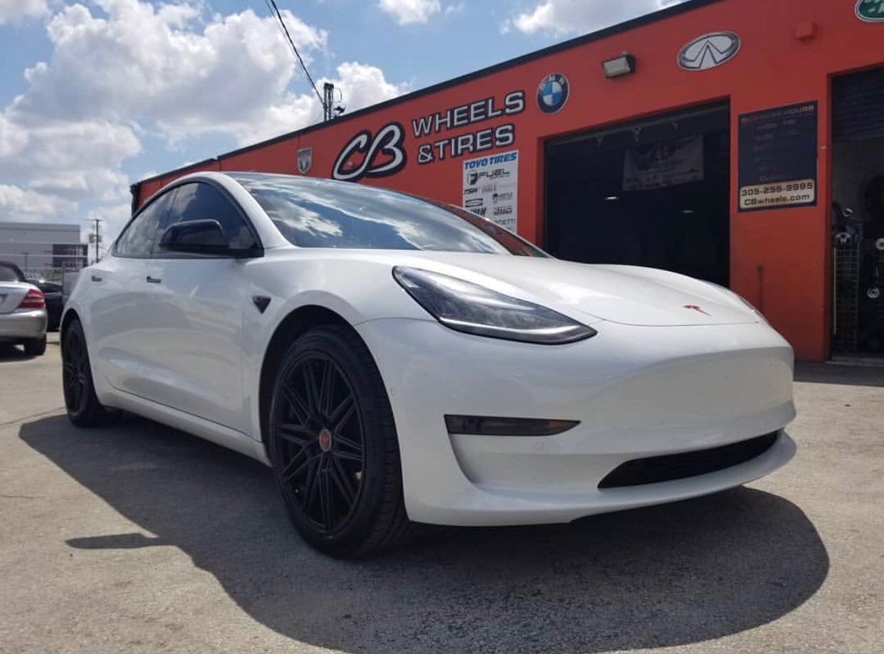 A white tesla model 3 is parked in front of cb wheels and tires | CB Wheels & Tires, 4x4, Suspension, Center