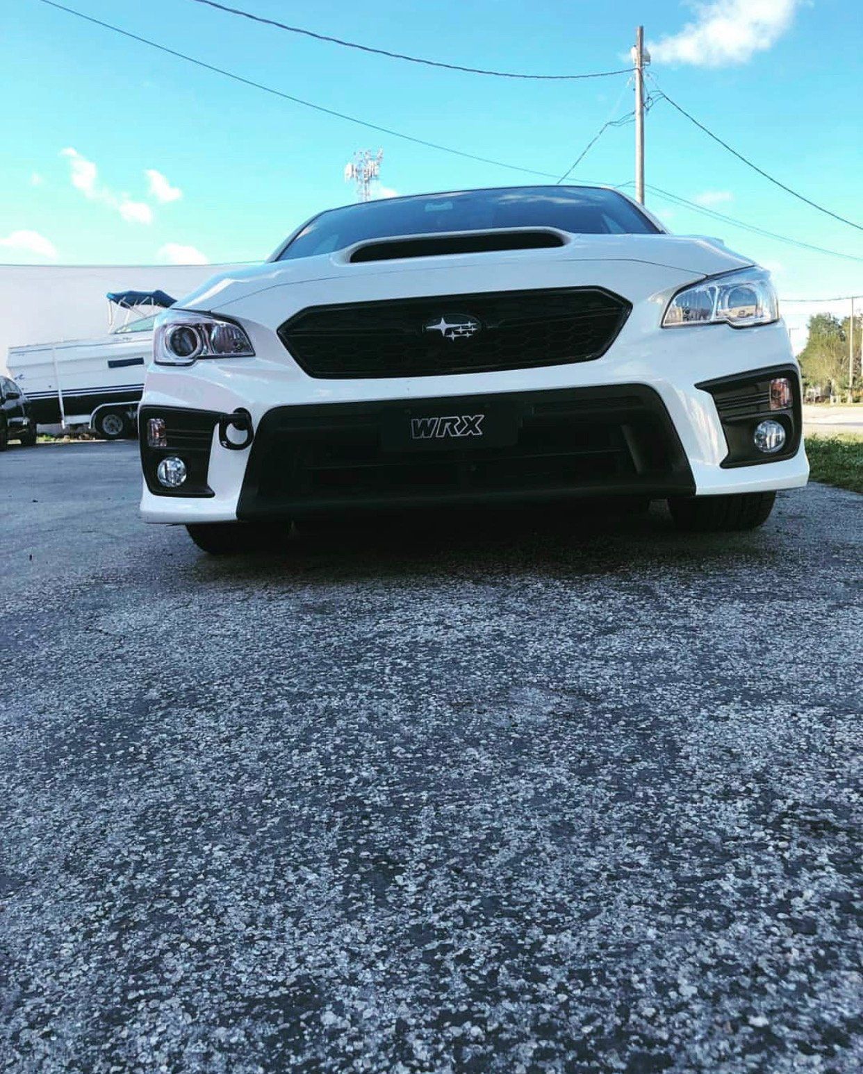 A white subaru wrx sti is parked in a parking lot. | CB Wheels & Tires, 4x4, Suspension, Center