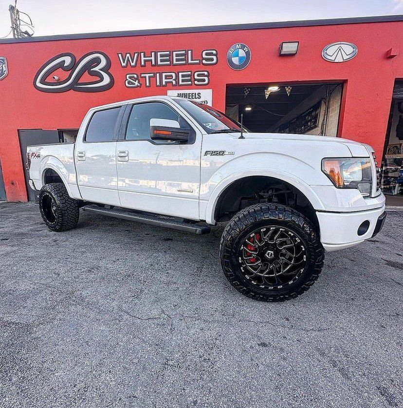 A white truck is parked in front of a cb wheels and tires store. | CB Wheels & Tires, 4x4, Suspension, Center