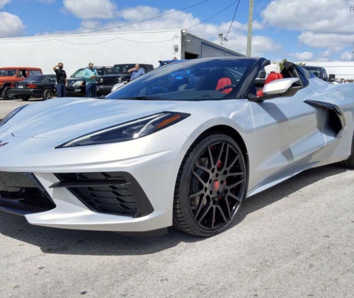 A silver sports car is parked in a parking lot | CB Wheels & Tires, 4x4, Suspension, Center