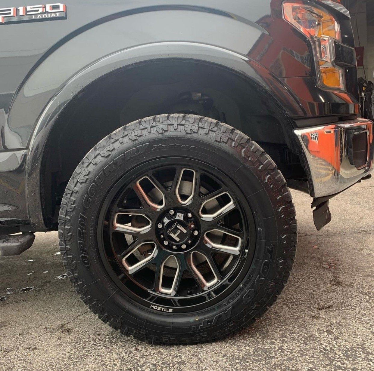 A black ford f150 is parked on the side of the road. | CB Wheels & Tires, 4x4, Suspension, Center