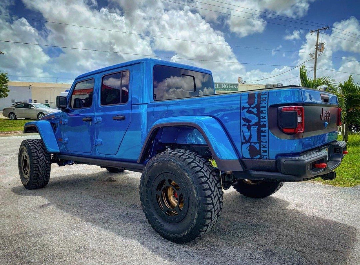 A blue jeep gladiator is parked on the side of the road. | CB Wheels & Tires, 4x4, Suspension, Center