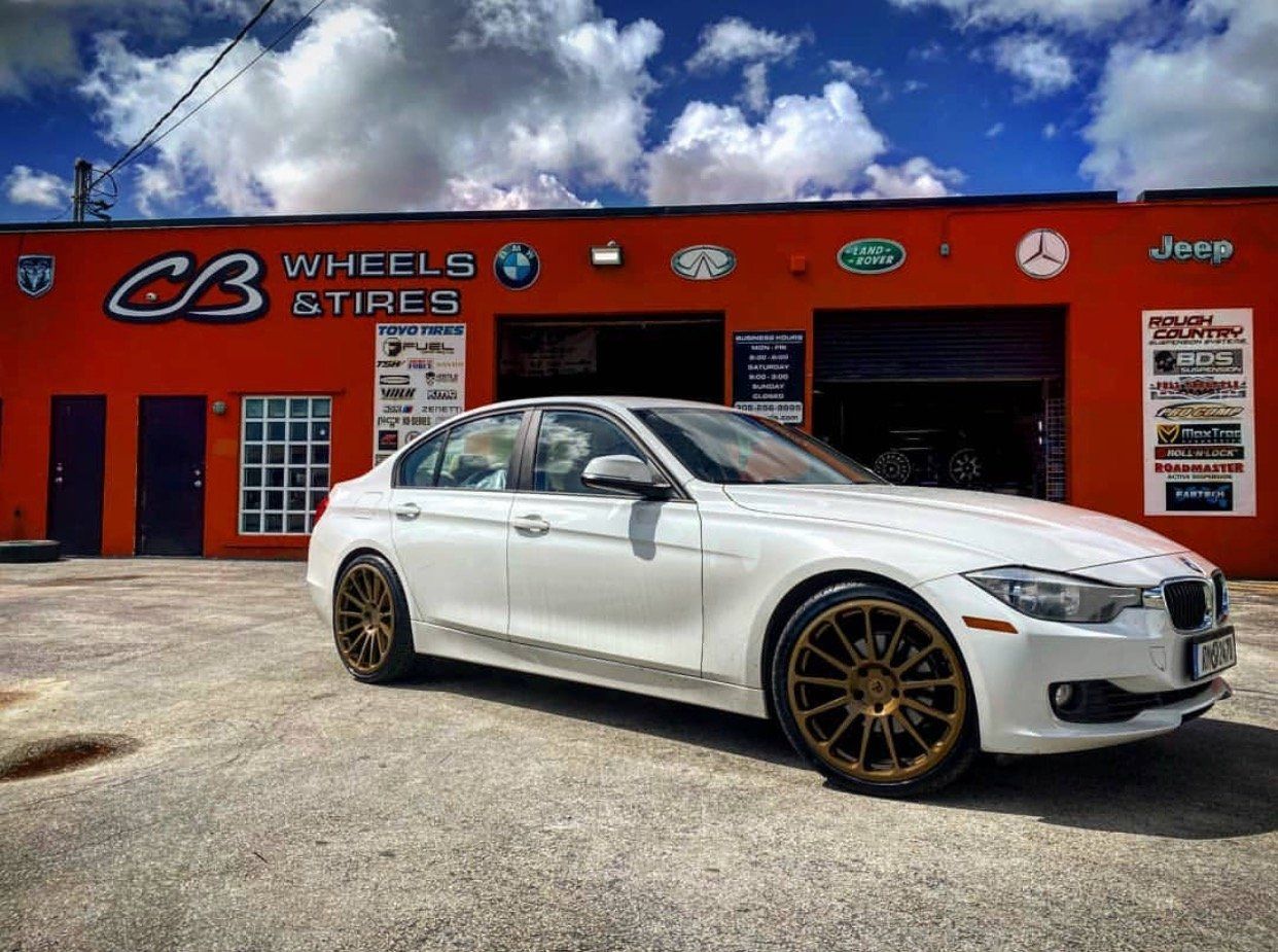 A white car is parked in front of a cb wheels store. | CB Wheels & Tires, 4x4, Suspension, Center