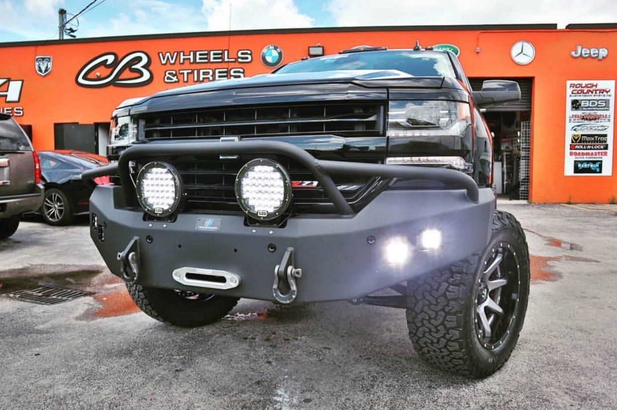 A truck is parked in front of a cb wheels and tires store. | CB Wheels & Tires, 4x4, Suspension, Center