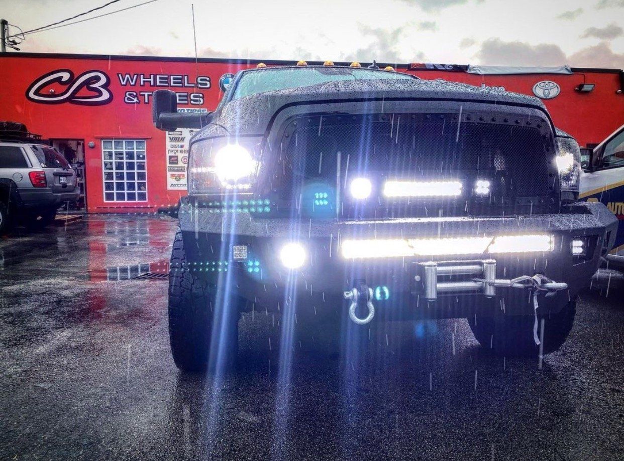 A truck is parked in front of a cb wheels store | CB Wheels & Tires, 4x4, Suspension, Center