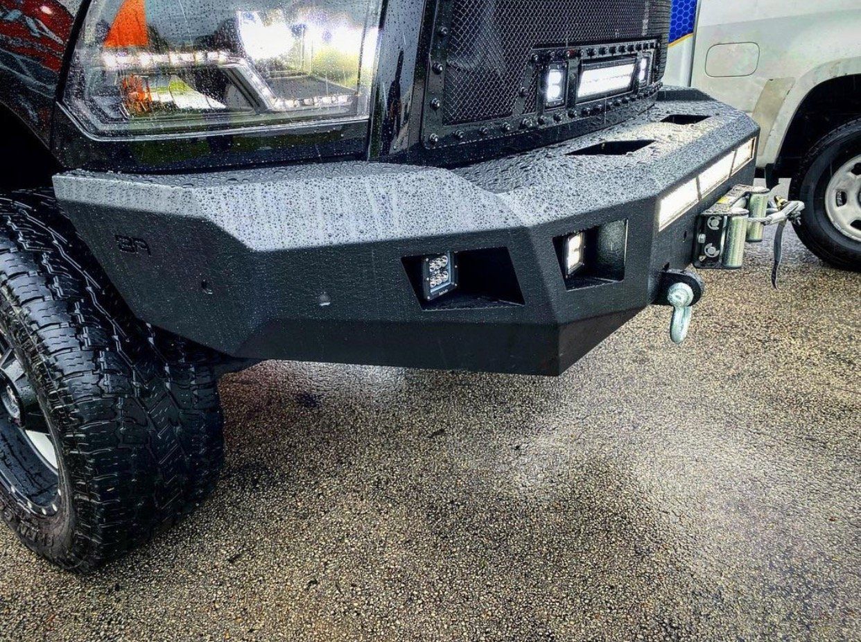 A black truck with a bumper on it is parked on a gravel road. | CB Wheels & Tires, 4x4, Suspension, Center