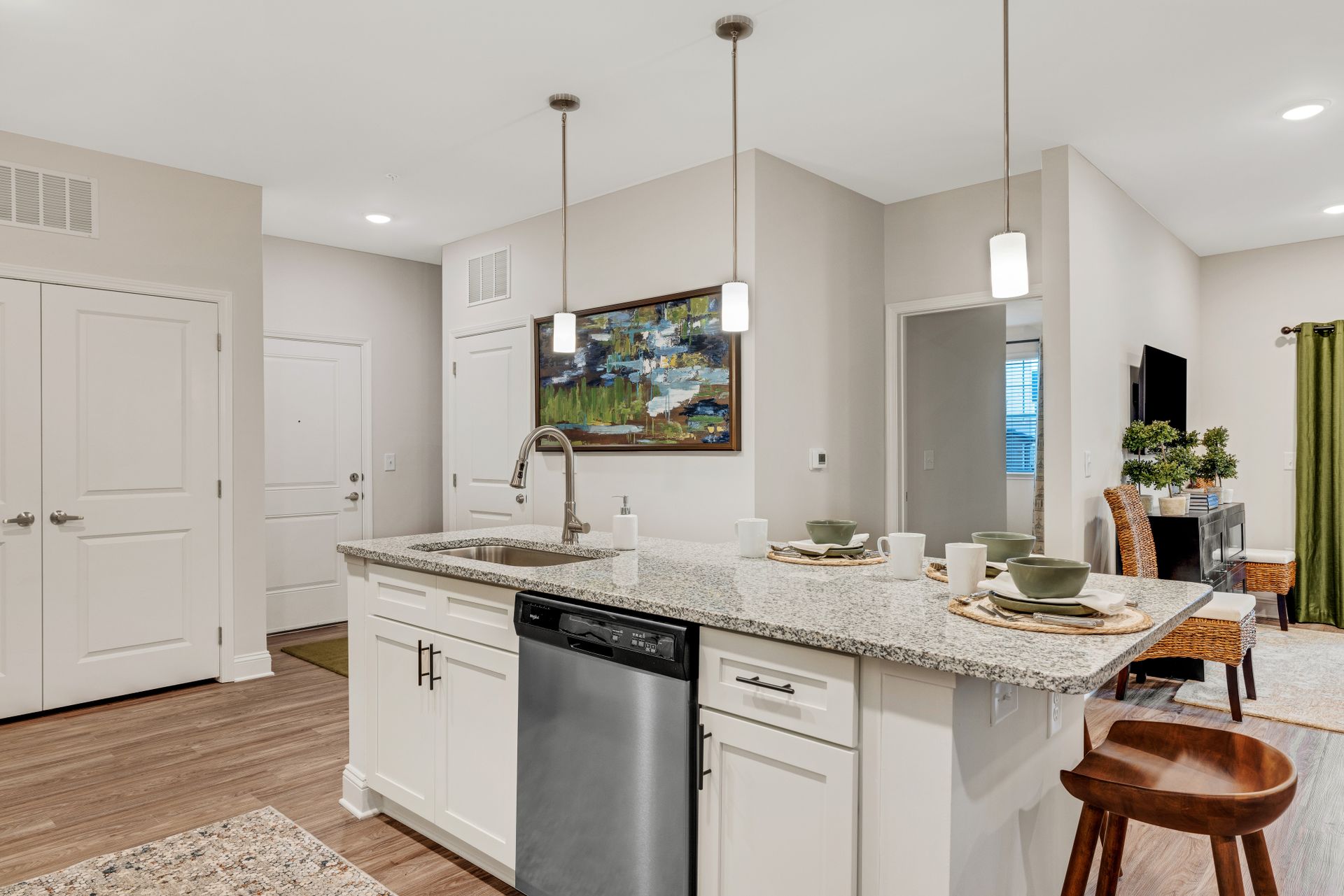 A kitchen with granite counter tops , stainless steel appliances , and a large island at The Standard at Pinestone. 