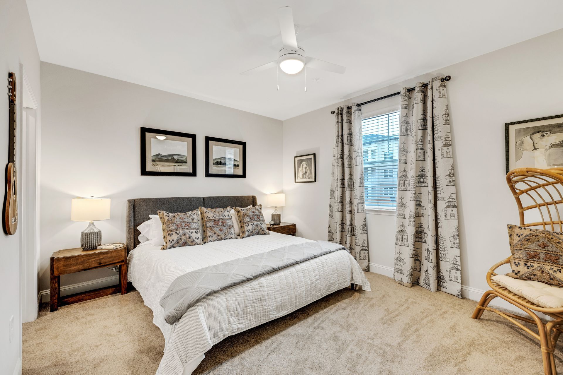 A bedroom with a bed , nightstand , chair and ceiling fan at The Standard at Pinestone. 